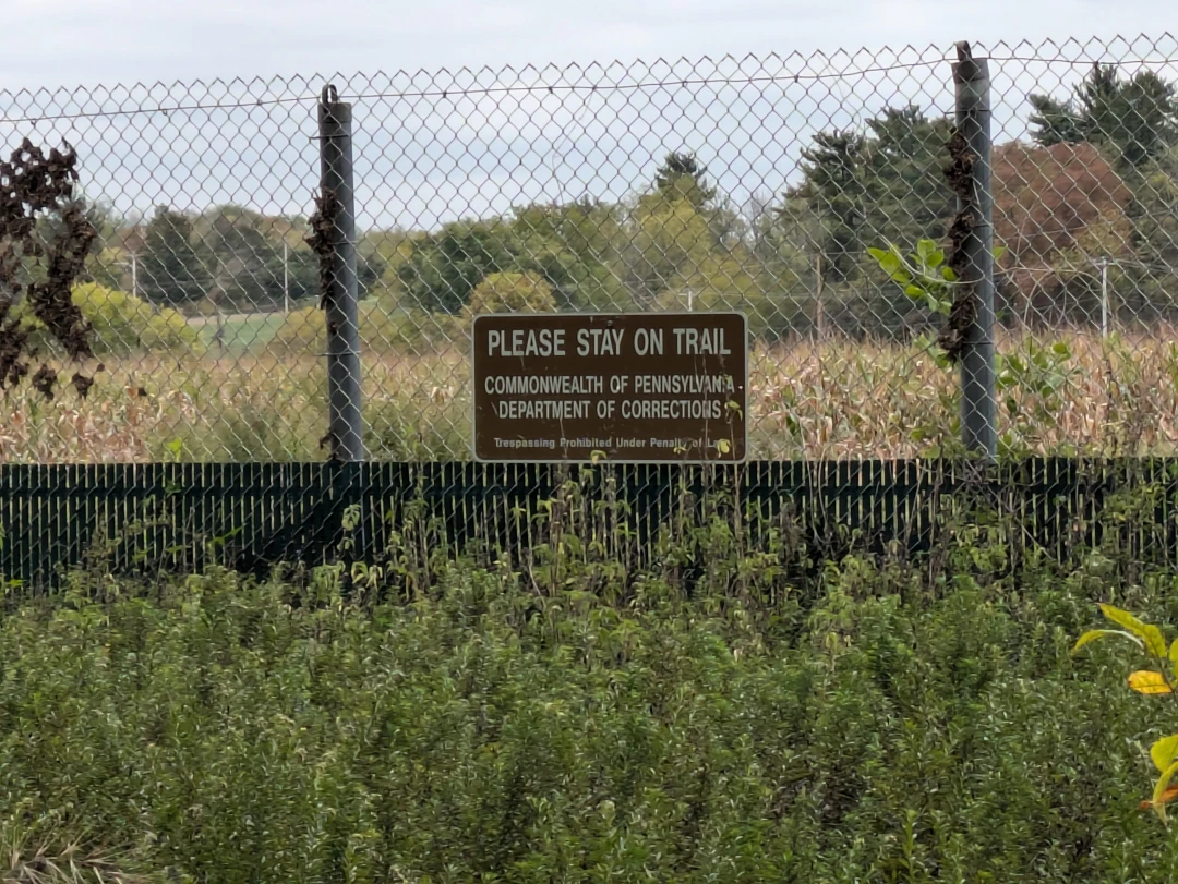 Not an alarming sign at all, especially since a section of the fence looked like inmates folded it down to esacape